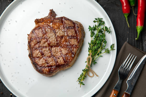 istock grilled steak on a white round plate. 1288427605