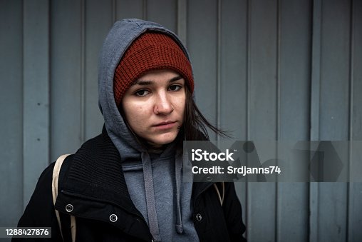 istock Very young hungry and scared homeless teenager girl standing alone on the street in the cold winter day feeling anxious and abandoned real people 1288427876