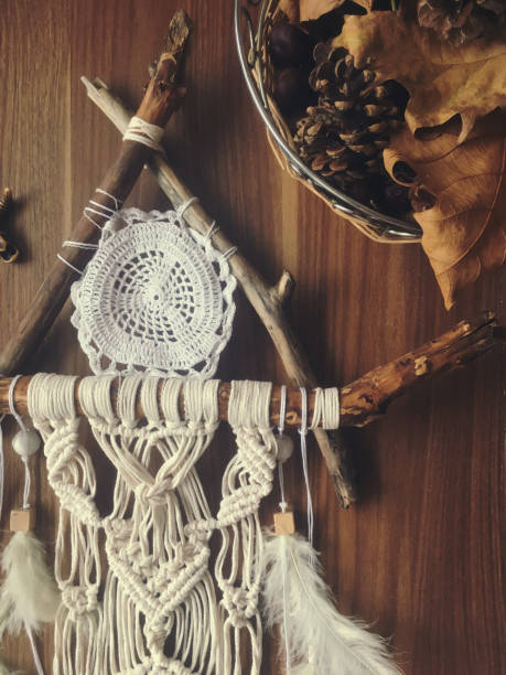 istock Handmade wall hanging white color with feathers. Home decor photo 1288428616