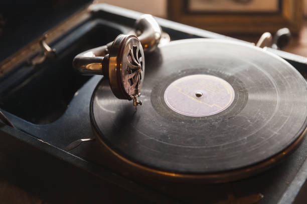istock Vintage phonograph with black vinyl record 1288430319