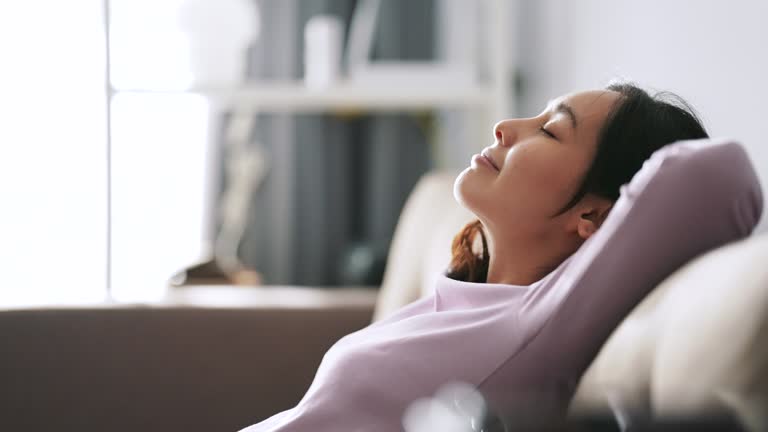Relaxation,Women,Sofa,One Woman Only,Tranquility,Living Room,Resting, Asian Woman relaxing at Sofa , Shoot format on 4K 4:2:2 10bit All-i