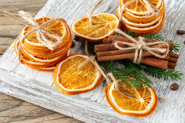 istock Christmas composition. Arrangement of dry Oranges, cinnamon sticks, fur tree branches and walnuts on wooden background. Rustic, Holiday spices ingredients 1288434466