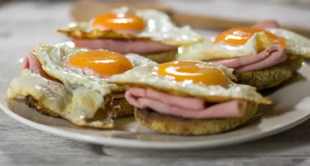 Fried eggs sunny side up with ham and toast. Selective Focus. Shallow depth of field