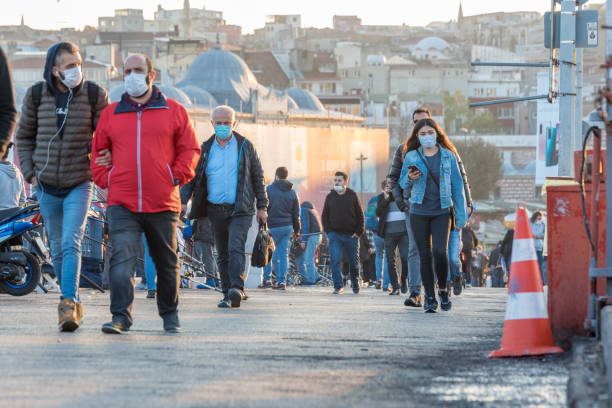 Turkish people wearing protective face masks and walking outside stock photo