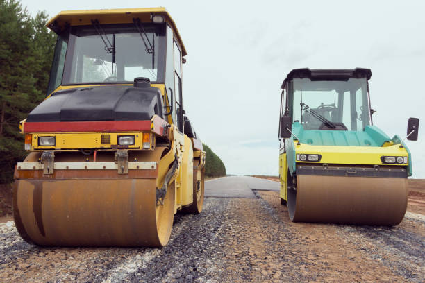 istock Special road vehicles. Compactor At Road Compaction Works. A roller compacting asphalt on a road 1288436936