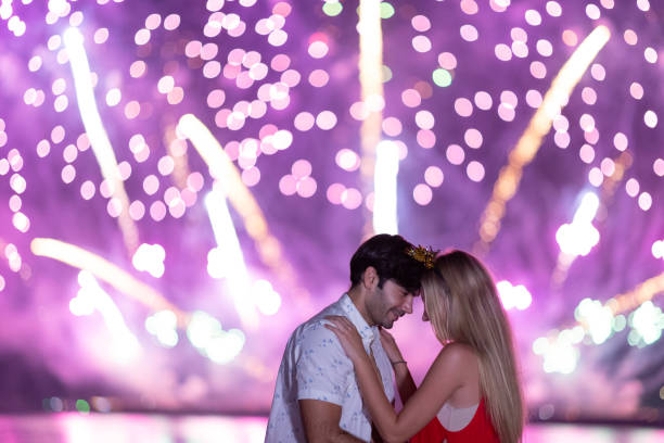 istock Young couple enjoy firework during celebration festival on the beach. 1288437002