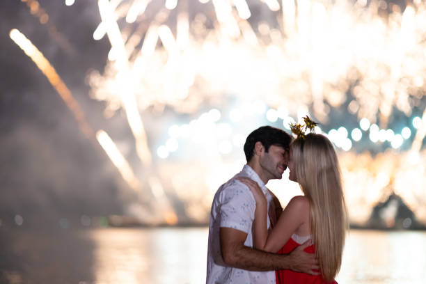 istock Young couple enjoy firework during celebration festival on the beach. 1288437022