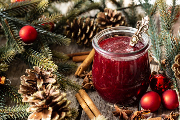 Homemade jam with cherrys decorated with pine cones and fir branches