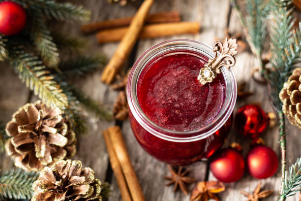istock Homemade jam with cherrys and mulled wine decorated with pine cones 1288437265