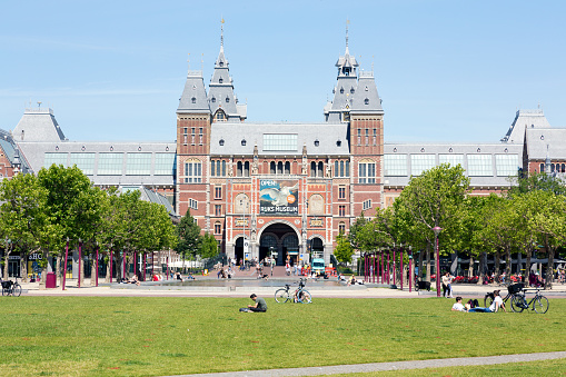 Amsterdam, The Netherlands, June 2020. View of sunny green grass Museum square with Van Gogh Museum, Rijksmuseum, Stedelijk Museum and Royal Concert Hall in Amsterdam.