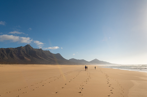 Children walking on Cofete beach, Fuerteventura island, Canary islands, Spain
