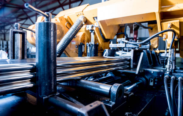 istock Automatic band saw machine with water coolant cutting metal pipes. 1288441940