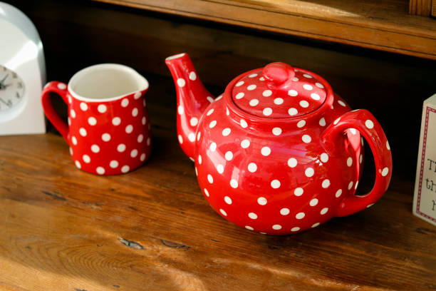 istock Red tea pot on wooden table 1288443150