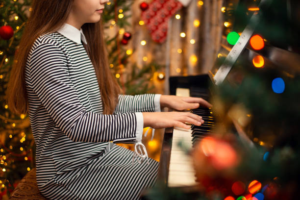 istock Playing the piano at christmas time at home. 1288446396
