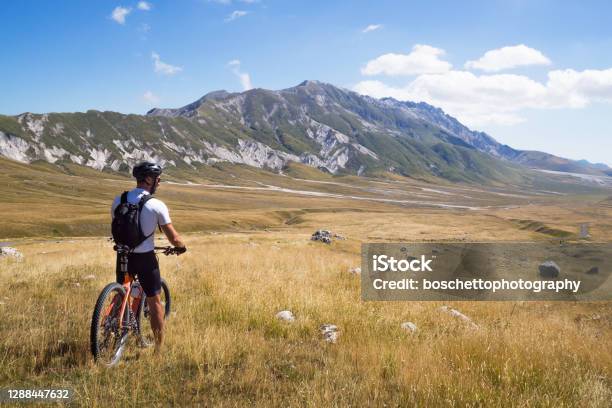 Mountain Biker Stopped On Mountain Trail With His Bycicle Enjoyng A Panoramic View Stock Photo - Download Image Now