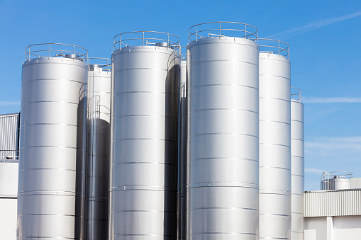 Stainless Steel storage tanks await deliveries of raw milk at the  dairy factory.