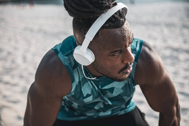 istock African athlete stretching at the beach 1288449028