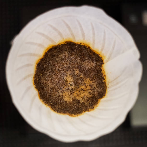 White coffee filter with grinded coffee and water