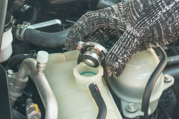 istock Car maintenance service, Auto mechanic Checking radiator cap for engine cooling. 1288451913