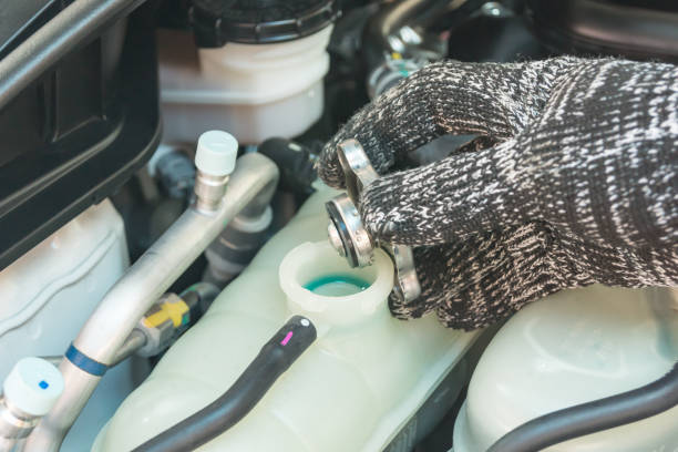 istock Car maintenance service, Auto mechanic Checking radiator cap for engine cooling. 1288451944