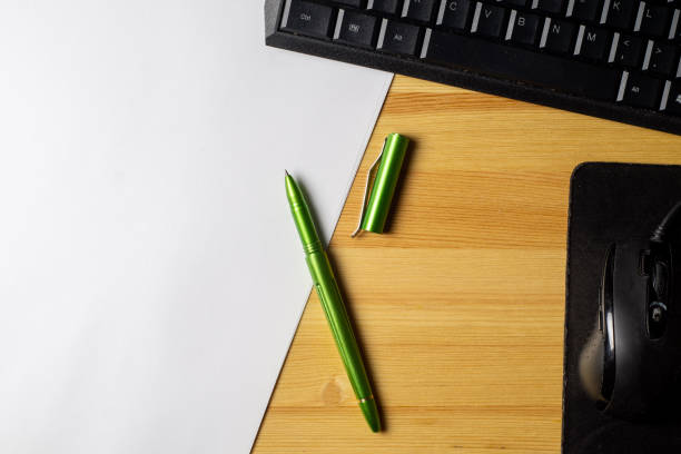 istock Notebook and laptop on old wooden desk 1288453502