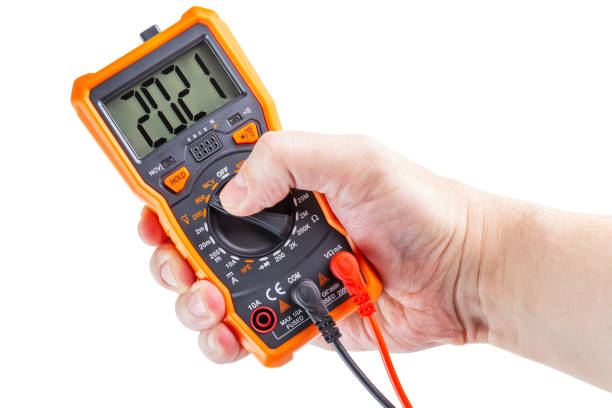 istock digit 2021 on lcd screen of digital electrical multimeter in left hand, isolated on white background 1288454451