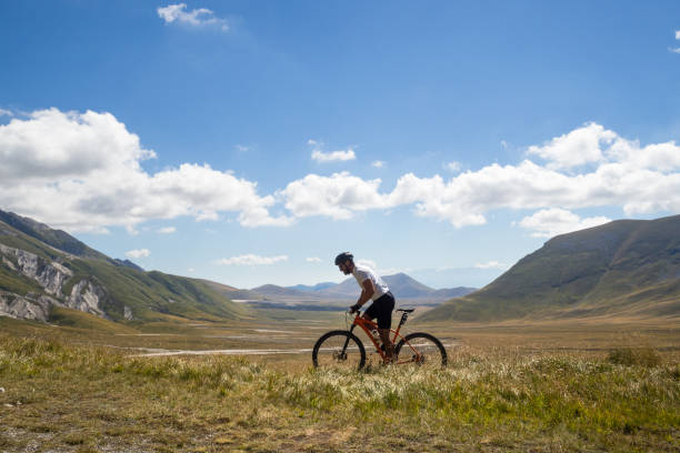 istock Mountain biker riding his bicycle on a mountain trail 1288456063