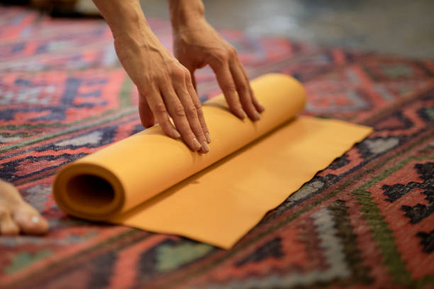 istock Woman rolling her mat after a yoga class 1288457750
