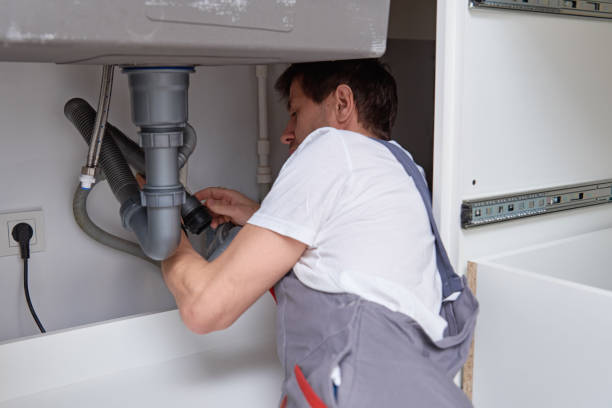 istock Male plumber repair sink pipe in kitchen 1288458229