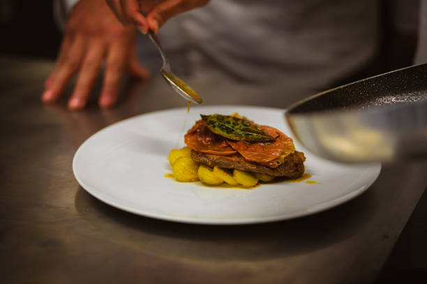 istock Close up of a Chef decorating a plate. Final Touch. 1288460789