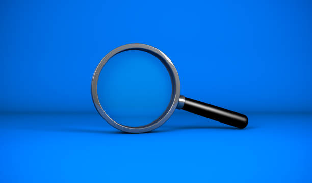 istock Close up realistic Magnifying glass on blue color background. 1288460855