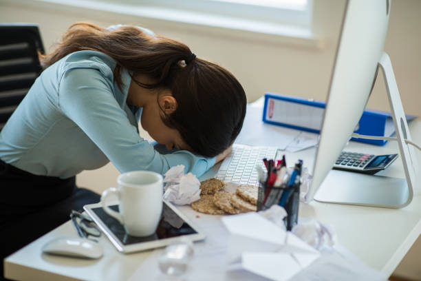 istock Exhausted woman hard working at office 1288462199
