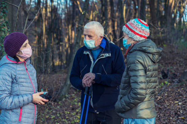 istock People wearing protective face mask in the forest 1288462579