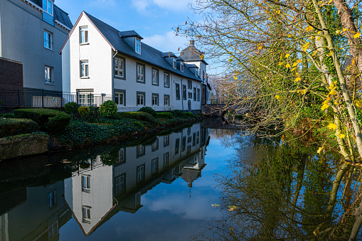 Amazing reflections in a pond on an autumn morning of an apartment building in Stein, Netherlands