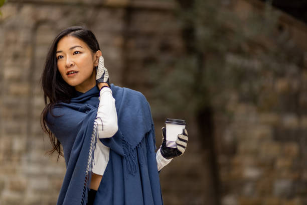 istock Beautiful young Asian woman drinking coffee 1288464006