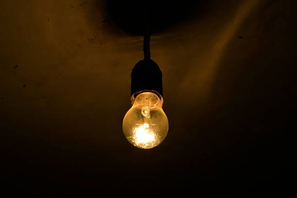 istock A burning incandescent lamp in a dark basement on the ceiling 1288466139