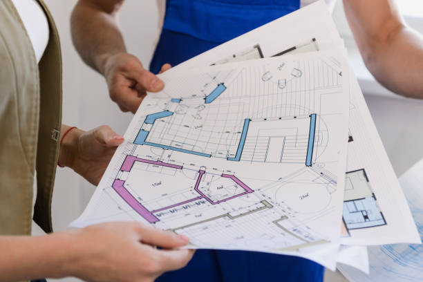 istock The client and the builders examine the scheme 1288466256