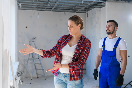 The female client is upset about the renovation in the apartment. The builder speaks to her