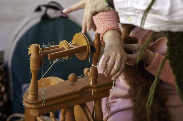 Spinner working in sewing with wool, artisan production, industry