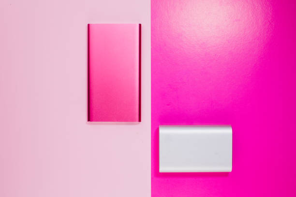 a pink and gray power bank on background