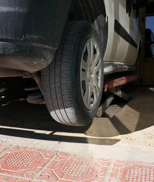 istock fitting winter tires on a car, tire mechanic, 1288469320