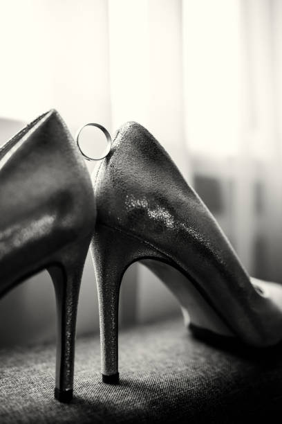 istock Wedding shoes with a wedding ring 1288470428