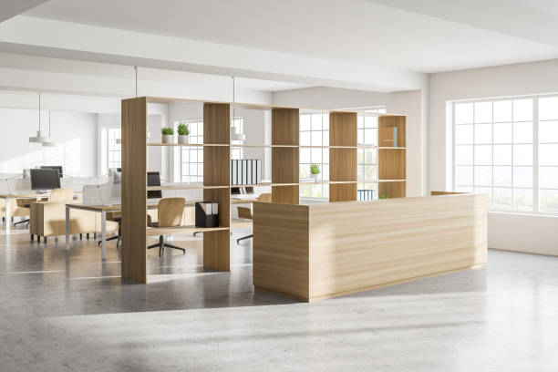 istock Modern white open space office corner with wooden tables and reception 1288475451