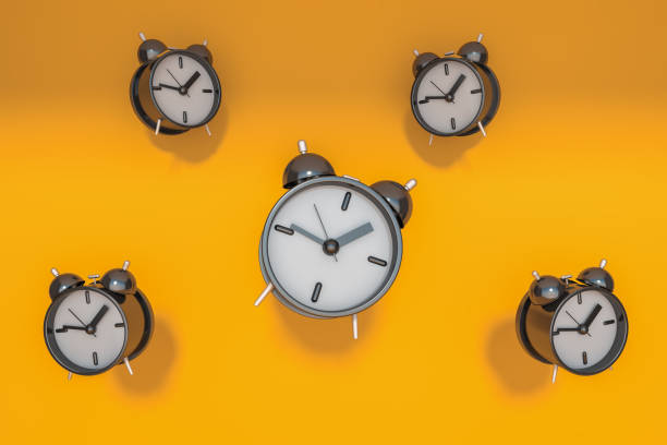 istock Five alarm clocks over yellow background 1288476448