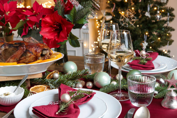 festive christmas day table with roast turkey and wine - poinsettia christmas candle table imagens e fotografias de stock