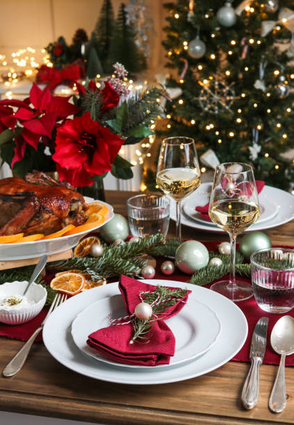 festive christmas day table with roast turkey and wine - poinsettia christmas candle table imagens e fotografias de stock