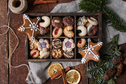 Delicious Christmas cookies on wooden table against blurred lights