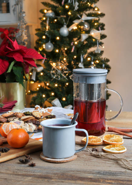 cozy winter mulled wine with christmas cookies in rustic kitchen - poinsettia christmas candle table imagens e fotografias de stock