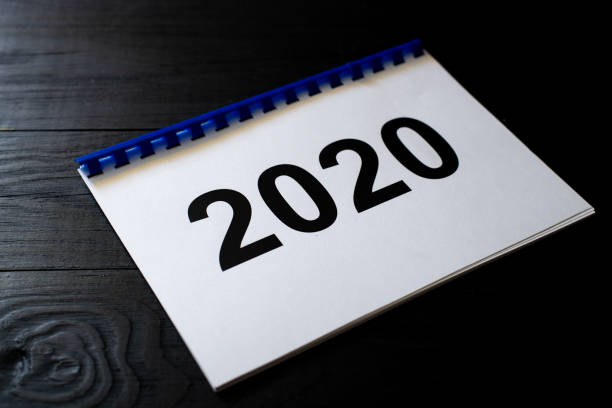 istock 2020 numbers on paper on a black background. 1288477832
