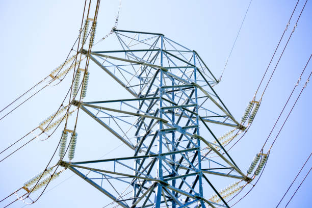 istock High voltage electricity pylon with overhead power lines, blue sky background with copy space 1288477842